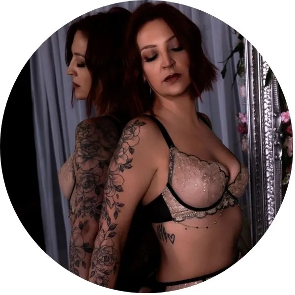Lady in neutral lingerie standing a gainst a mirror