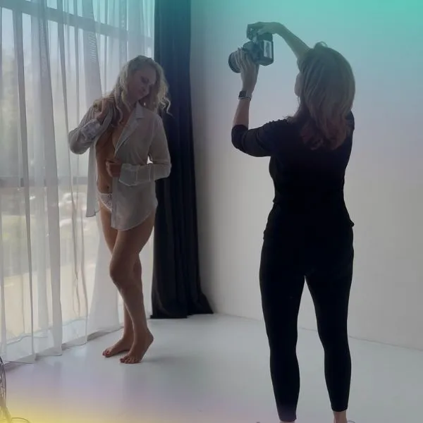 Lady being photographer during her boudoir photo shoot